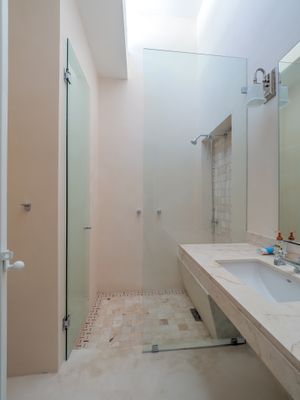 Light and airy bathrooms with stone benches and 2 shower heads, overlook your private garden. at Casa Kaan in Merida