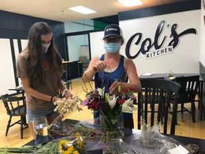 Sierra and Kristy prepare flowers for opening day at Col's Kitchen in Concord