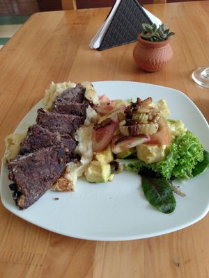 Lunch of the day: black bean patty on mashed potatoes. Salad with lettuce, avocado and tomato at El Arrebato in Medellin