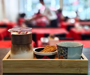 Signature coconut latte with biscuit set. at North South East West Fusion Vegetarian Restaurant 东南西北素食融合餐馆 in Central Singapore
