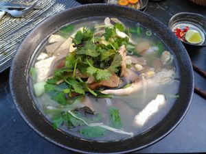 Saviry udon noodle soup with fresh herbs, tofu and saitan at Com Chay in Mannheim