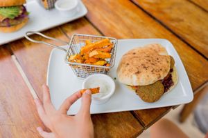 If you love the pitta falafel try this, this is a pita bread filled with falafel, hummus, cucumber, tomato, carrot, purple onion, lettuce, coriander sprout and vegan ranch dip at Lido Beach Club  in Playa Del Carmen
