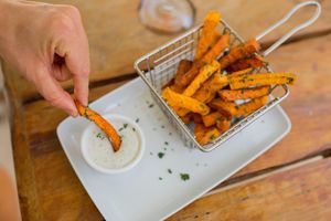 I've never try the sweet potato but this omgare so delicious it are crispy seasoned with vegan ranch dip at Lido Beach Club  in Playa Del Carmen
