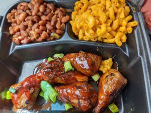 Yummy tasty smoked wangs with sides of BarBQ baked beans and creamy mac and cheese. Yeah, finger licking good. at Houston Sauce Pit in Houston