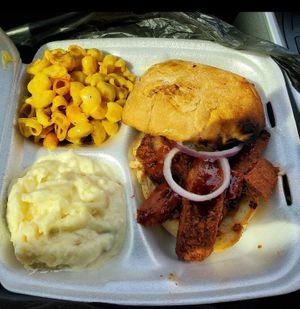 Sausage link sandwich with potato salad and mac (2023) at Houston Sauce Pit in Houston