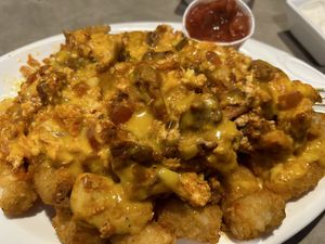 Breakfast burrito filling over tator tots  at The Bayside Cafe in Everett