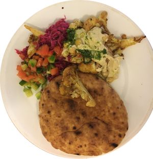 Cauliflower takeout transferred to a plate. at Tamam - Upper East Side in New York City