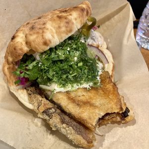 Sabich Pita, Spicy w/ a bite out of the eggplant   at Tamam - Upper East Side in New York City