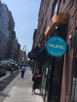 View from street, 30 minutes after official opening time. Notice the nervous customer with a huge order looks in vain for somebody to open up. at Tamam - Upper East Side in New York City