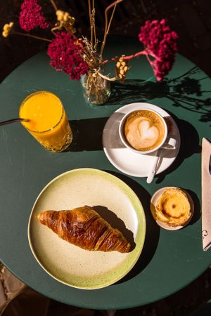 Breakfast! Vegan croissant, jus d'orange, oat-milk cappuccino & vegan pastel de nata!  at Jacob's Juice in Amsterdam