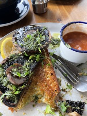 Portobello mushrooms on sourdough with a side of beans   at New Ground in Harlow