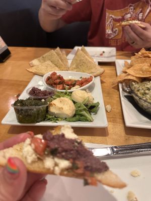Bruschetta after we’ve each had a piece with vegan almond cheez  at Seva - Ann Arbor in Ann Arbor