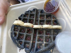 Charcoal waffle with blueberries, coconut whipped cream, maple syrup, cacao nibs at BOL in Wellfleet