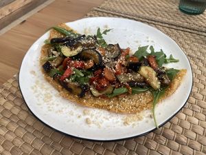 Pizza "Farinata" with vegetables at SawaBona Art Café in Amposta