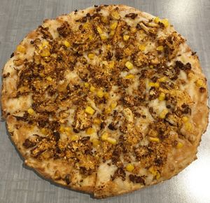 Vegan Kerala Coconut Pizza (coconut curry, sweet corn, ‘gunpowder’ & scallions). Non-traditional ingredients with bold flavors. at Bombay Pizza Kitchen in Plymouth