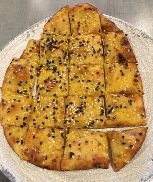Garlic Naan Bites (veganize by asking for a vegan dip). Nice appetizer size. Kind of like a flat pretzel. at Bombay Pizza Kitchen in Plymouth