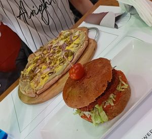 Red bean burger and white veggie pizza at Plant Power in Novi Sad