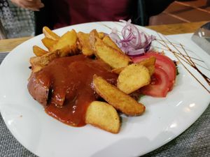 BBQ ribs, fries, and a lot of raw onion at Plant Power in Novi Sad