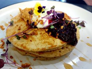 Banana pancake with coconut yoghurt and mix berries couli at Dfrent Cafe in Victoria Park