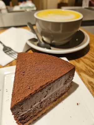 Eggless chocolate cake and Turmeric & honey latte with almond milk at Cedele - Raffles City in Central Singapore