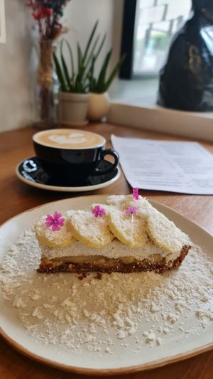 Banoffe pie with a flat white with oat milk. at Plantiful - Plant-based Cafe in Bangkok