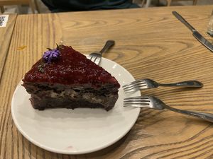 Peanut butter chocolate cake with raspberry - heavenly   at Plantiful - Plant-based Cafe in Bangkok