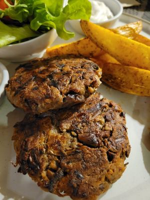 Meaty mushroom patties and potato wedges at Goodsouls Kitchen in Bangkok