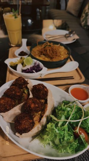 Mango lassi (135 THB), Khao soi (180 THB), Falafel & pita bread (240 THB)  at Goodsouls Kitchen in Bangkok