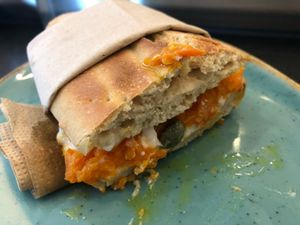 Spelt bread with smoked carrot, fermented horseradish cream cheese and capers at Hasard in Biel
