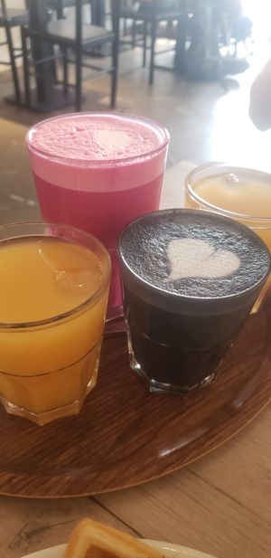 Fruit juice, "black metal" (coffee latte) and "bloody" beetroot latte at Lucifer Lives in Brussels