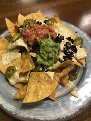 These are the vegan nachos , the cheese is so BOMB, they come with beans but they didn’t have any so they replaced with mushroom. Super good  at The Downtowner in Stockton