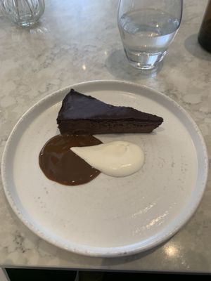 Chocolate torte. Have no idea what we’re the sauces but they were incredible especially the white one!! 🤩  at Holy Carrot in London