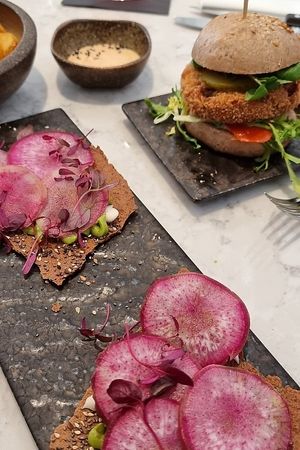 Radish & avocado toasts, Burger with oyster mushroom patty at Holy Carrot in London