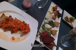 Tomato bruschetta on gluten-free bread, cheese board, smoked tofu rolls, and smoothies. at Saf - Kensington in West London