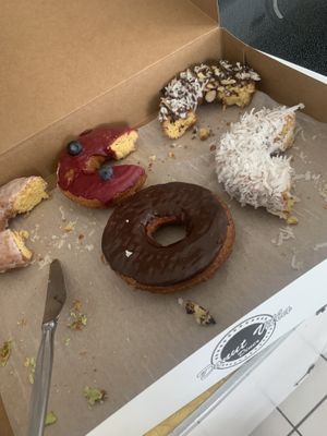 Half eaten donuts because we couldnt wait to chow down!!!  SO good!! Highly recommend the pistachio!   at Donut Villa Diner in Malden