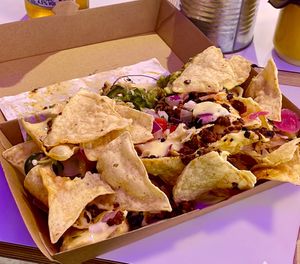 “Half” a Fully Loaded Nachos in a doggy bag to take home.   at Club Mexicana - Soho in London