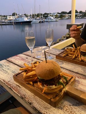 Burger with table right on the water  at Ebb and Flow Darwin in Larrakeyah