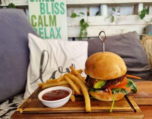House made beetroot and walnut patty, with avocado, salad, sauerkraut, pickles and vegan aioli on a potato bun at Ebb and Flow Darwin in Larrakeyah