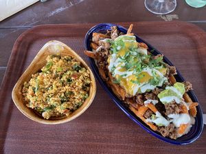 Sweetpotato fries with minced meat, Guacamole and Cheese. Bulgur salad on the left   at Dominion Food Revolution in Frankfurt