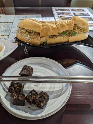 Partially eaten "pig blood cake" made with sticky rice 👍 +  Banh mi slightly adjusted by owner to make it vegan at Tiān Cí Bǎo Xuān 天慈寶軒 in Yuli