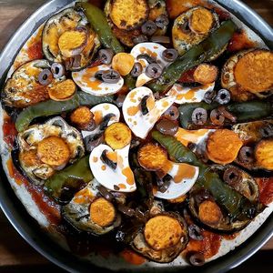 Vegan focaccia with roasted eggplants, sweet potatoes, peppers, mushrooms, olives and handmade tomato sauce at Artognosia Bakery in Paphos