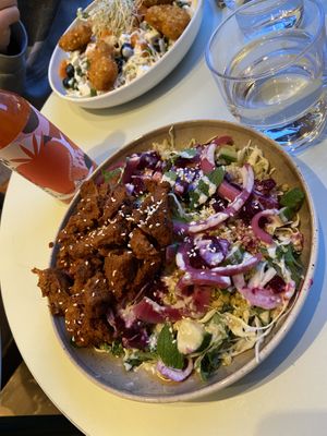 Salad with quinoa and soy bites, topped with tahini and lime dressing. Plus strawberry kombucha!   at Naturli' in Oslo