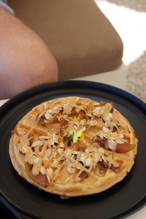 Waffle with peanut butter, maple syrup and caramelized apples 🍎  at Fotis All Day Bar in Naoussa