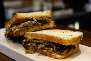 Vegan panini made with homemade sourdough bread. This one is caramelized onions and mushrooms, with homemade vegan sun dried tomato mayo. Soo good! at Café Mellemfolk in Aarhus