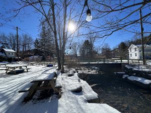 Backyard along the creek, cute sitting area   at Haven Market in Livingston Manor