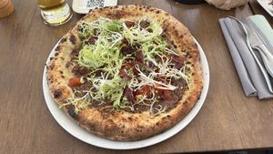 One of the 4 vegan pizza. This one is the Veganella. Base is puréed olives. Very oily. Couldn’t finish it.  at Luigia in Fribourg