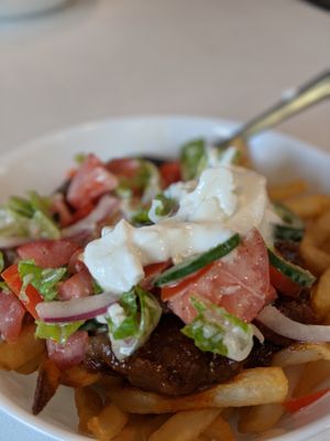 Vegan and Vegetarian poutine. Air fried delicious french fries topped with rich lentil sauce, kidney bean salad dressed with home made tahini dressing. Call us for other toppings at Red Cherry Cafe in Winnipeg