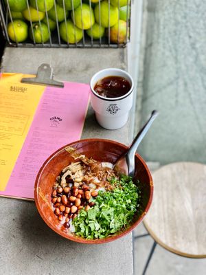 Congee - banana flower, oyster mushrooms, ginger rice, cilantro, spring onion, chilli and Sichuan oil, peanuts. at The Cool Cat in Warsaw