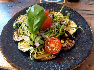 Vegan starter: grilled courgette, pine nuts, salad, tomato, garlic-balsamico dressing at Gewoon Bij Roon in Castricum