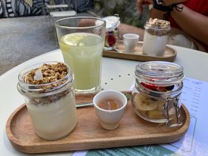 Granola, fresh fruit and vegan vanilla yoghurt; ginger and mint lemonade at Maria Limão in Porto